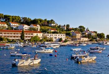 Boats are anchored in the waters off of Hvar.